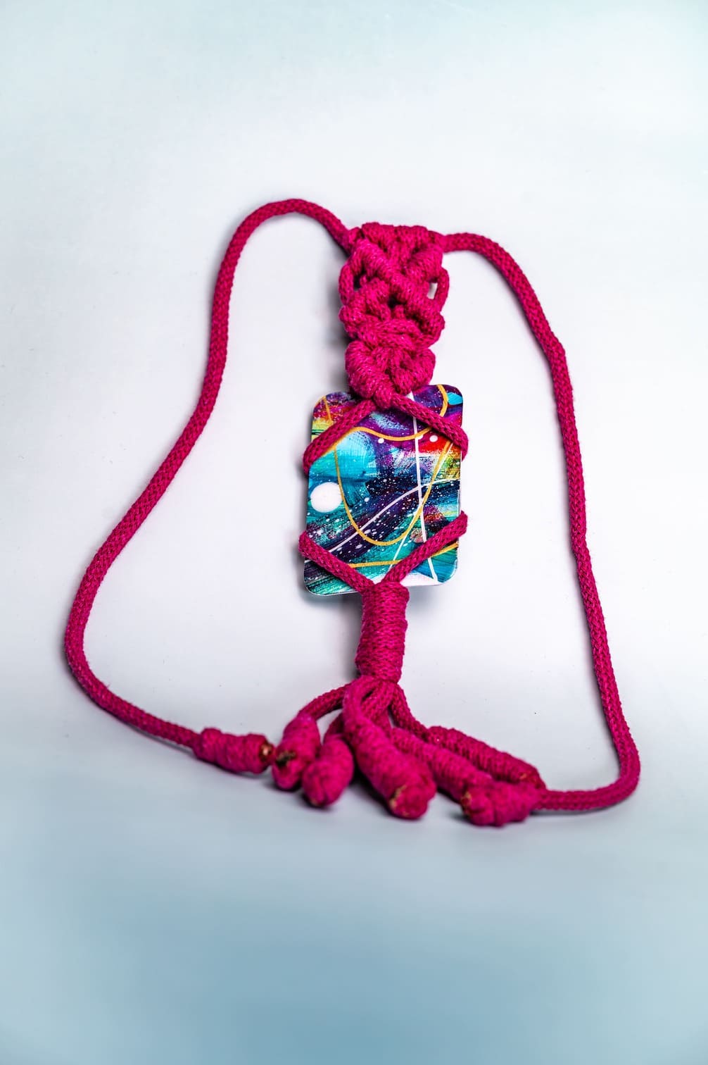Artistic amulet with colorful fragment and special weaving