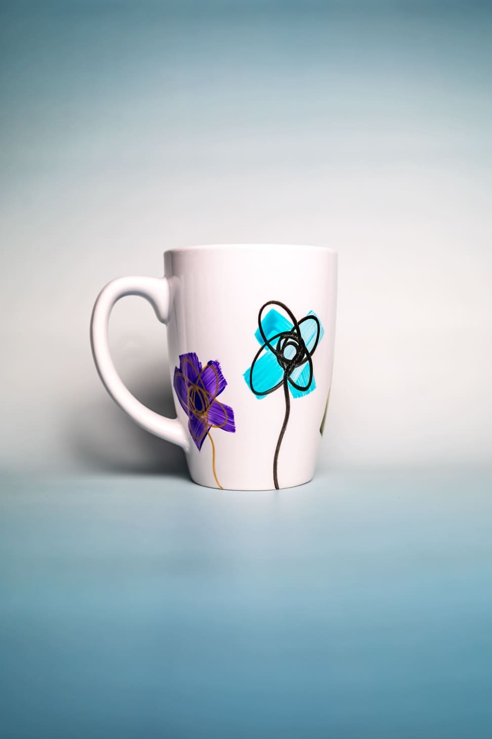 Hand-painted ceramic mug with abstract design